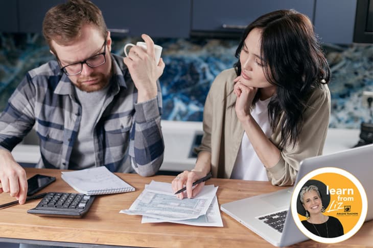 man and woman working on budget