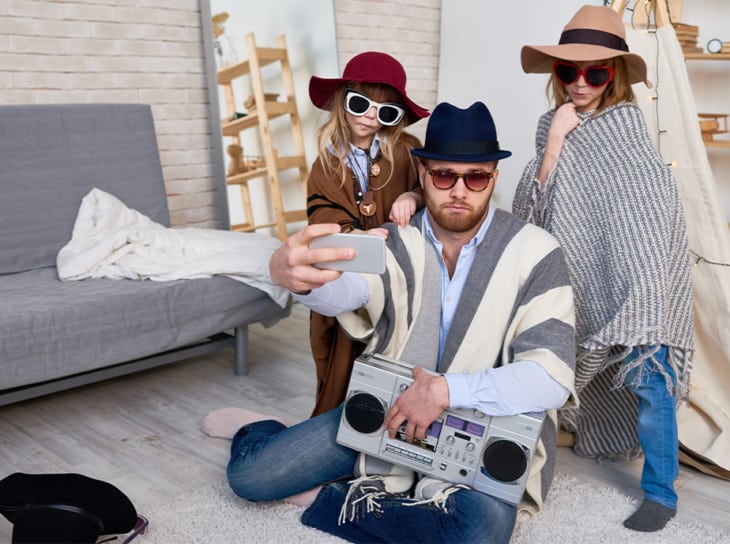 father and two daughters playing dress up