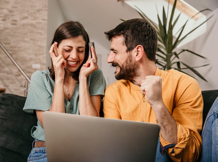 Couple of couch using laptop