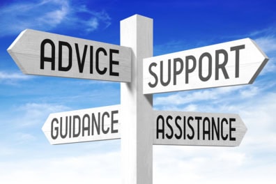 White wooden signpost with four arrows - "advice", "support", "guidance", "assistance".