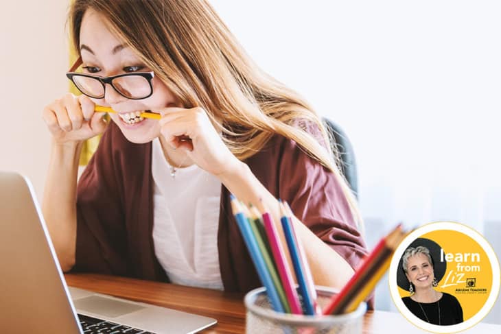 Girl biting a pencil in frustration