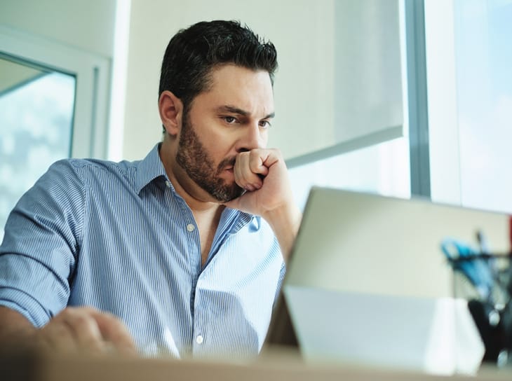Worried business man using laptop