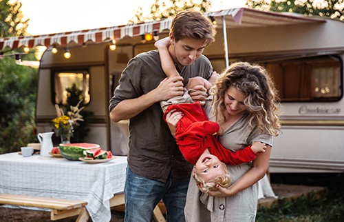 Young family camping with a recreational vehicle