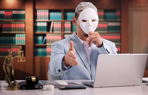 Well dressed businessman holding a mask in front of his face and offering to shake hands