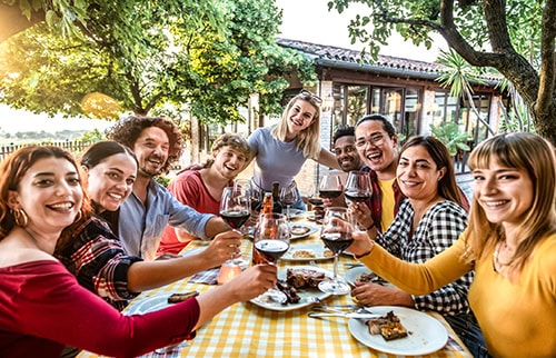 Group of friends eating a meal at an outdoors restaurant
