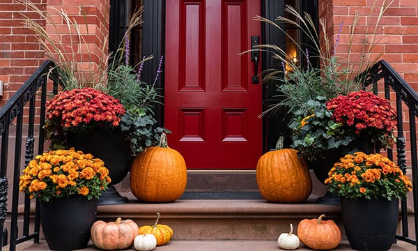 Front porch of home decorated colorfully for autumn