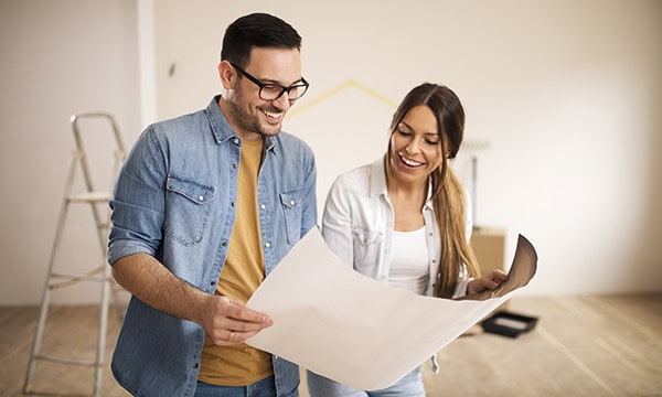 Homeowners looking at a remodeling blueprint