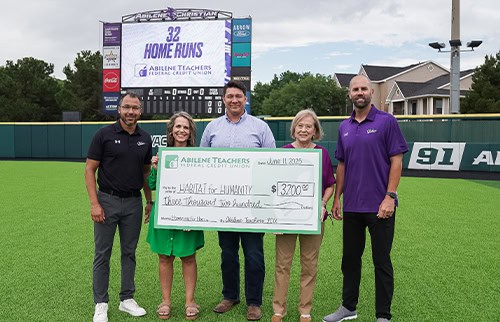 picture of ATFCU employees presenting a check to Habitat for Humanity employee alongside ACU staff