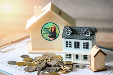 miniture homes with coin and keys on a contract