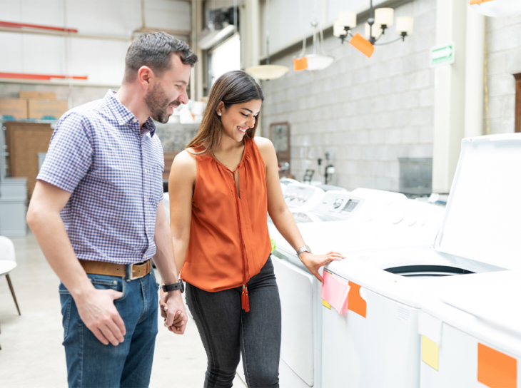 Couple pricing washers and dryers