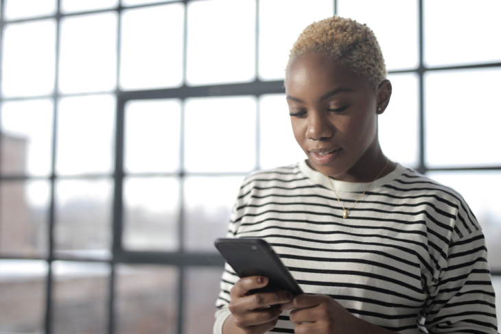 Teen consulting her iPhone