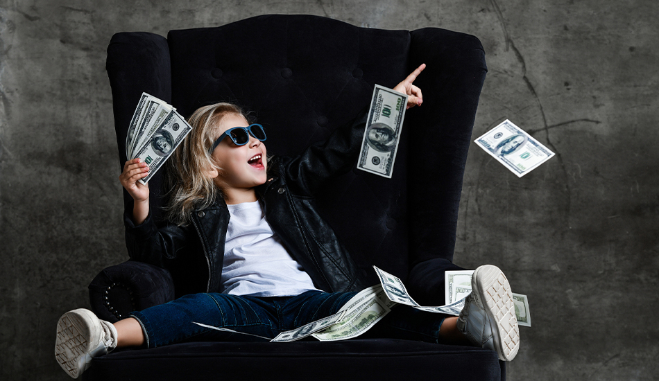 Young girl in velvet chair with play money
