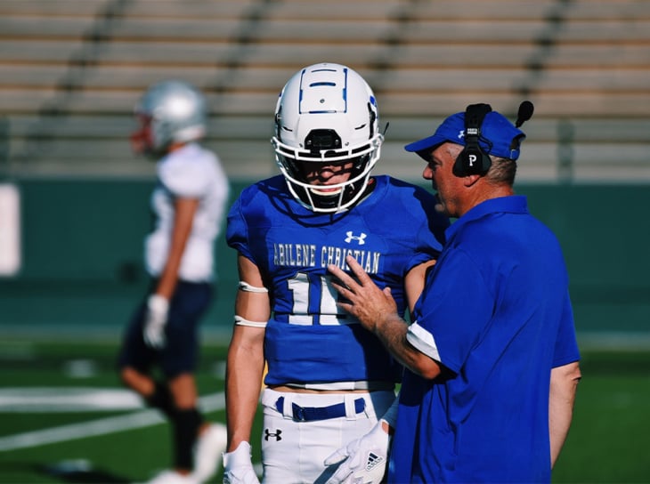 ACU coach talking to football player