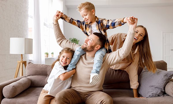Happy young family sitting on a sofa