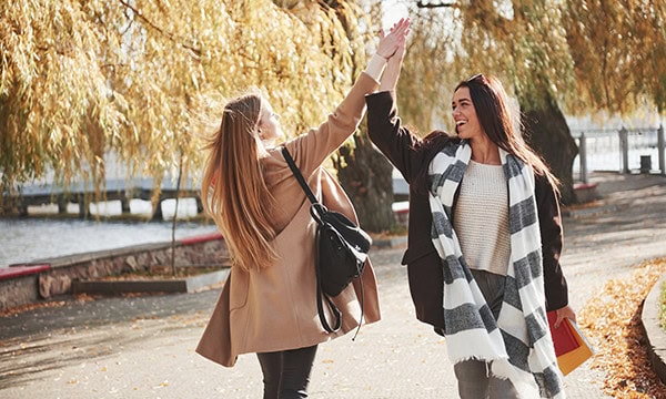 Two women exchanging a high five greeting