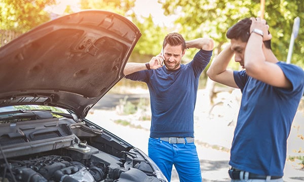 Two men frustrated by a car breakdown