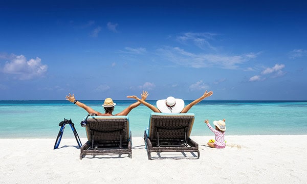 Family of three relaxing at the beach