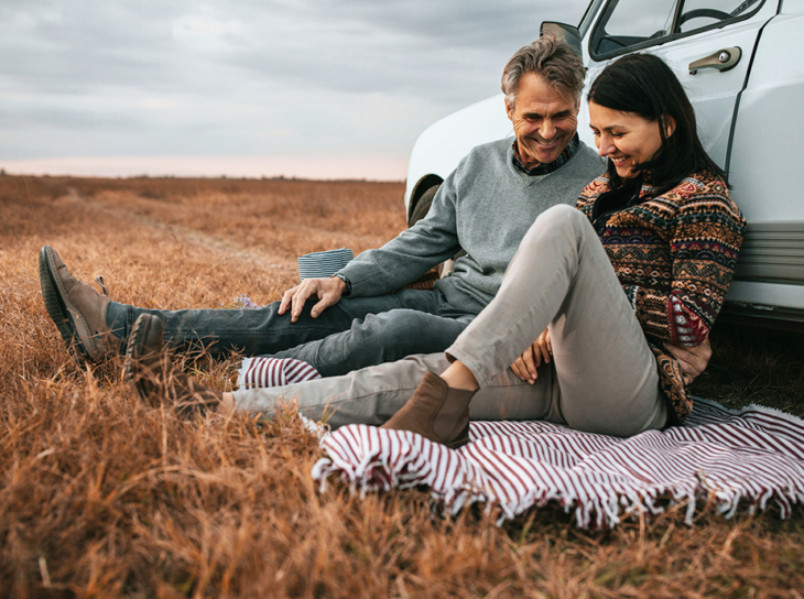 couple having picnic in field