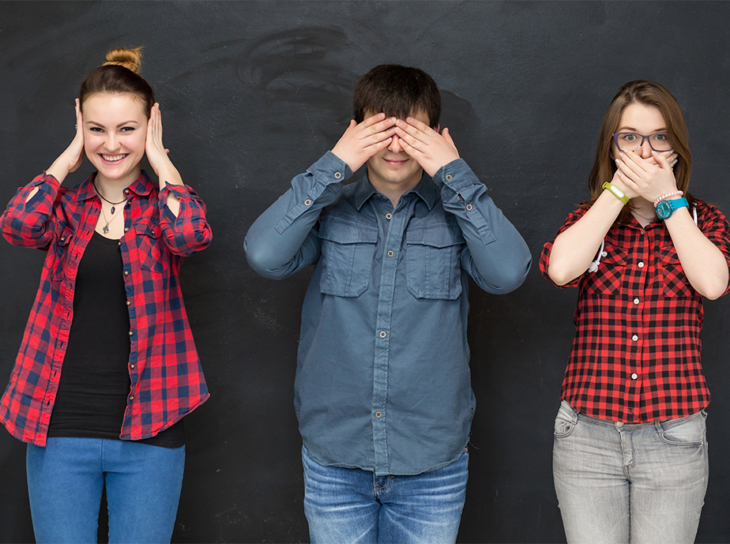 Three teens in see, hear, speak no evil pose