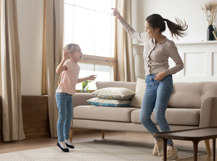 Mother and child dancing at home