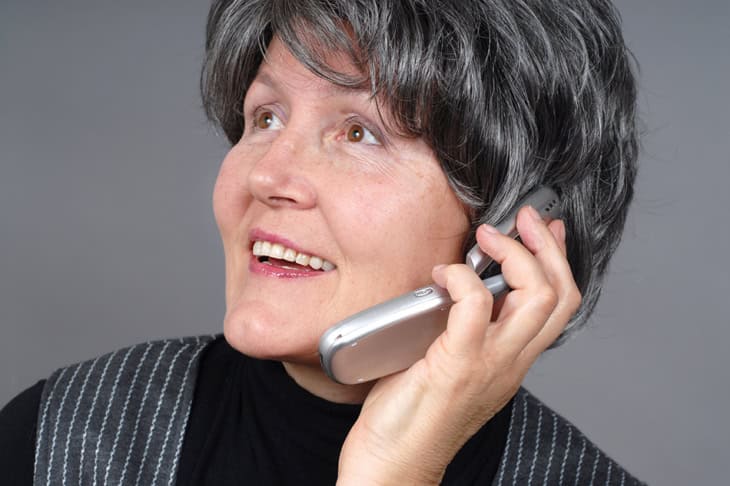 Female adult talking on the phone and smiling
