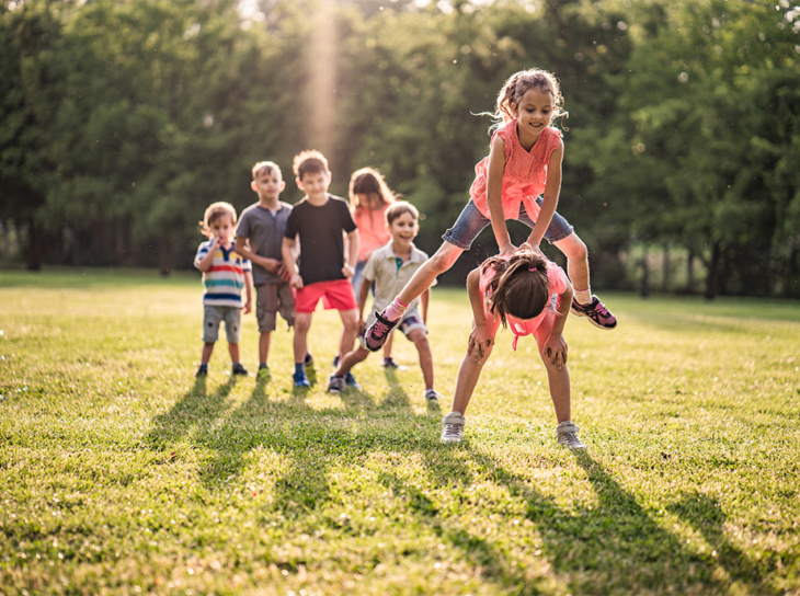 Group of children playing leap frog