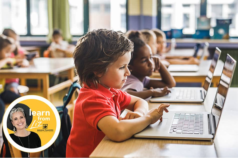 children in a classroom on laptops