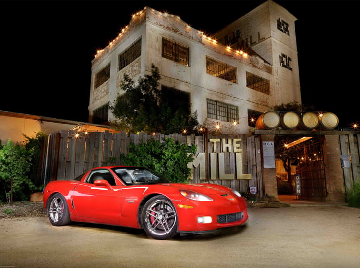 Red sports car parked in front of The Mill