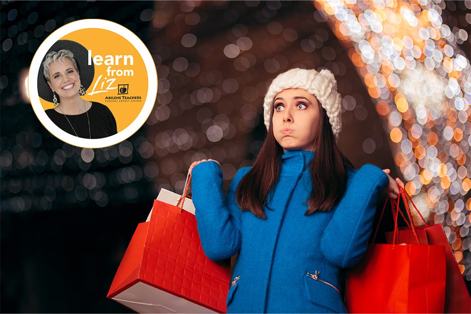 bewildered woman holding shopping bags outside under Christmas lights