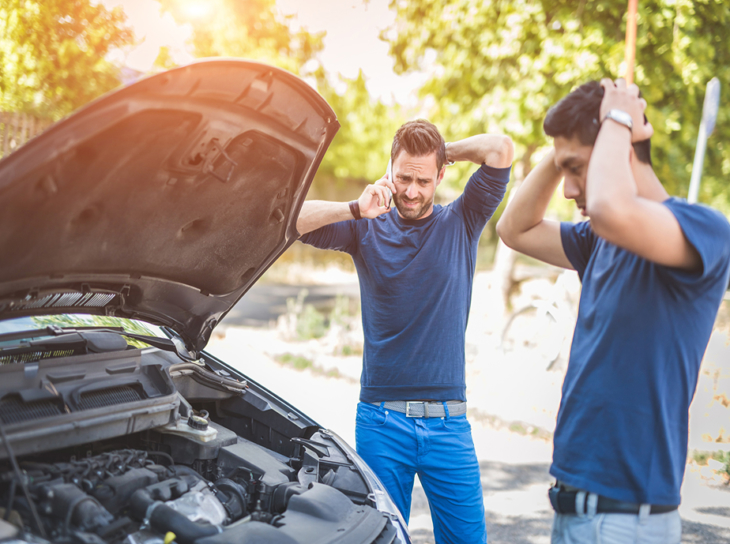 two men with broken down vehicle on roadside