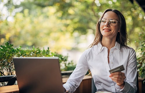 Woman shopping online in outdoor cafe