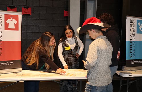 Laura and Emilee helping Wylie high school students with their budget