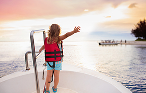 child standing at front of boat