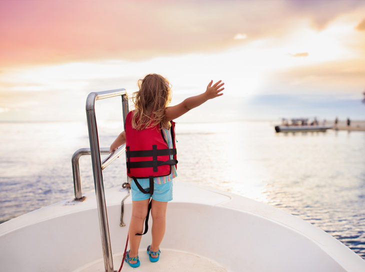 child on boat bow