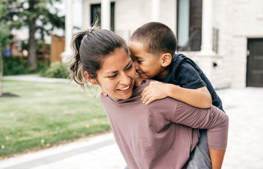 child on womans back