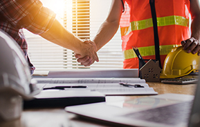 constructions workers shake hands