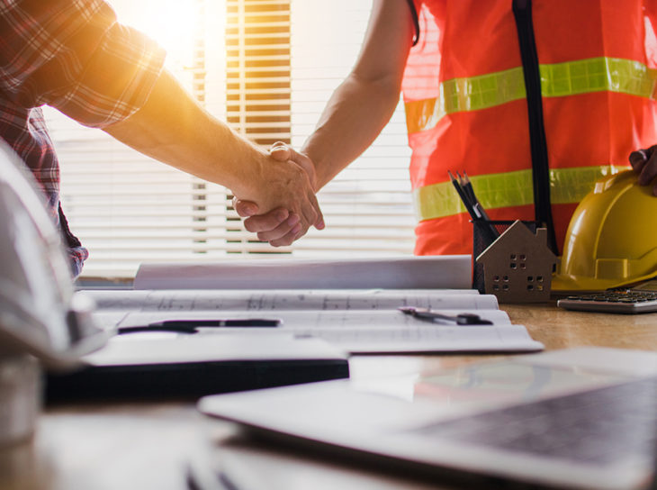 construction workers shaking hands