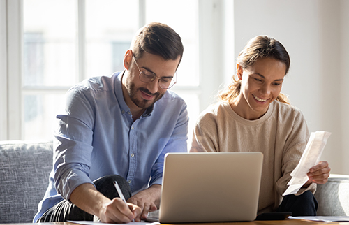 couple sorting expenses at home