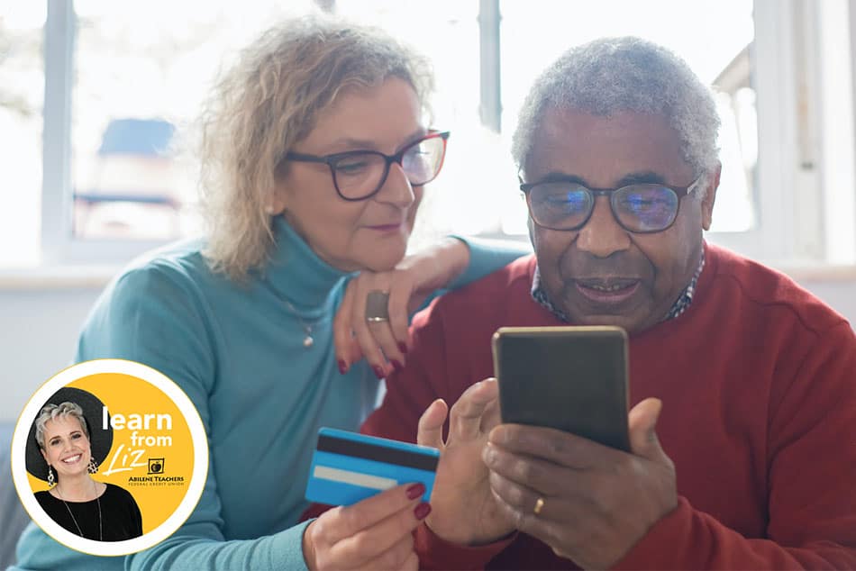 older man and woman looking at phone