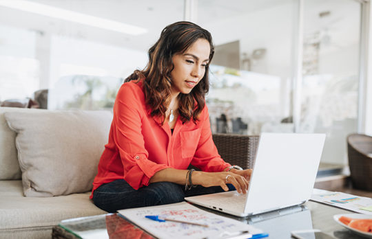 woman using laptop to bank from home