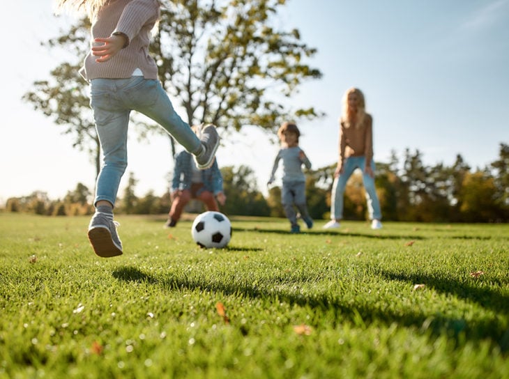 family playing soccer