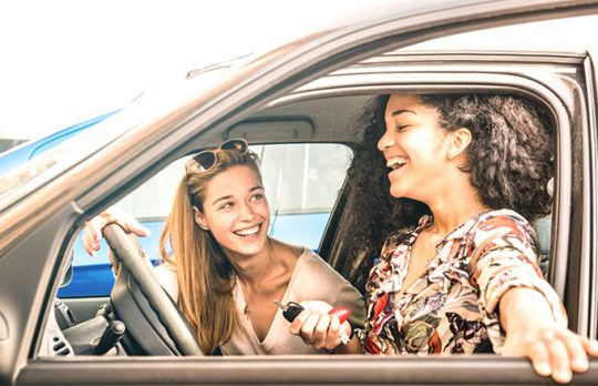 friends laughing in car