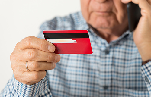 man reading credit card number on phone