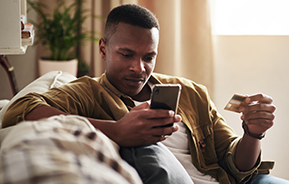 man using credit card on smartphone