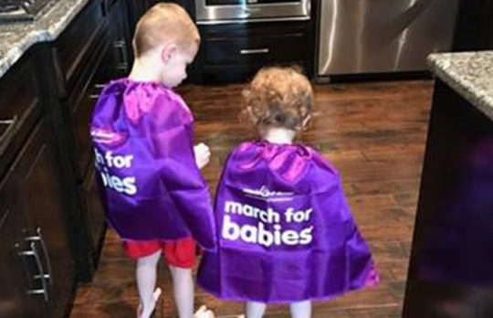 Two children in purple March for Babies capes