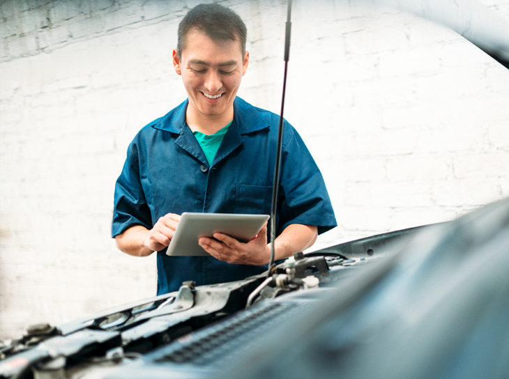 mechanic looking at car engine