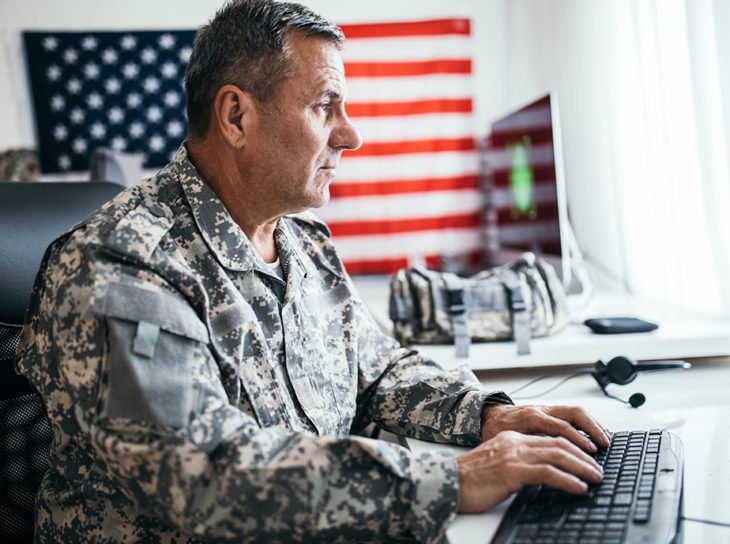 military man at computer