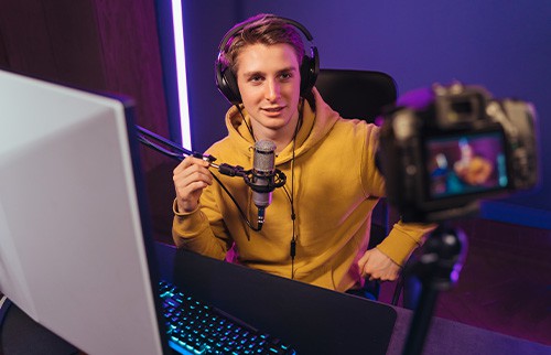 teen boy at computer with microphone and camera