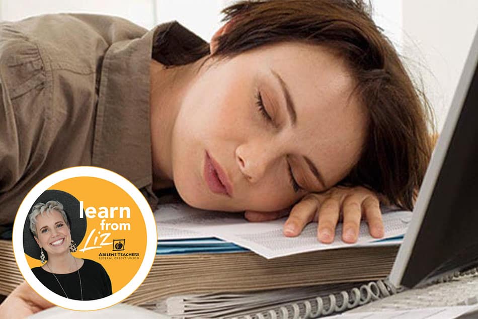 woman sleeping on stack of books and laptop