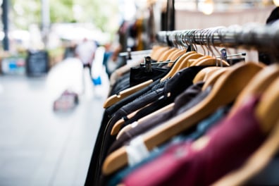 Clothes lined up on store rack